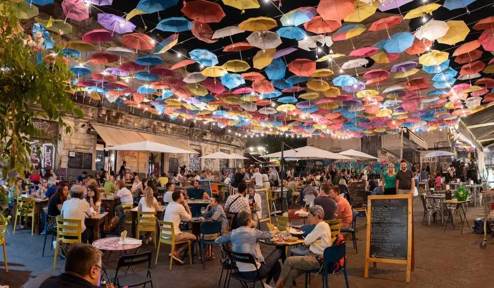 Catania, Sicily - September 21, 2022: Old town with colorful umbrellas over the street in Catania, Sicily island, Italy